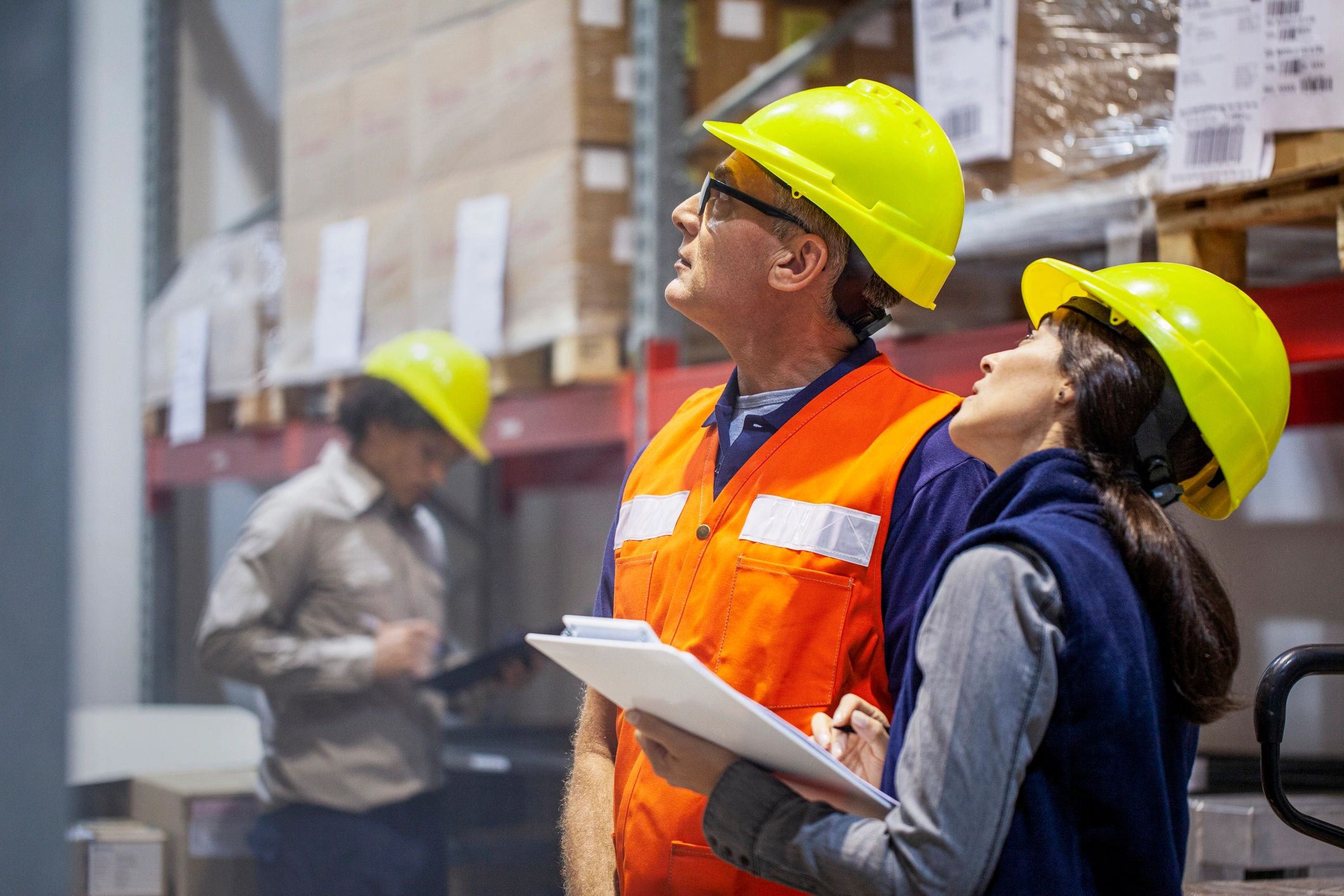 Warehouse manager and team member reviewing operations in a storage facility